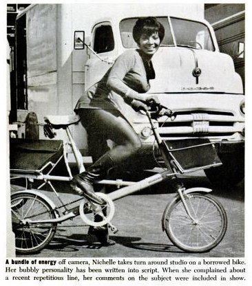 Nichelle Nichols rides a folding bicycle