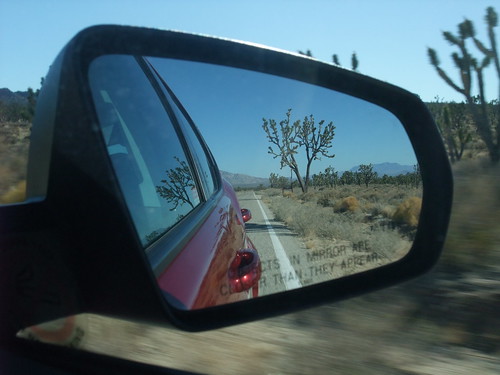 Desert road in car mirror