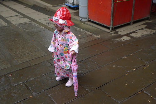 Little girl in a cute raincoat
