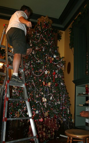 tinseling the top of the tree