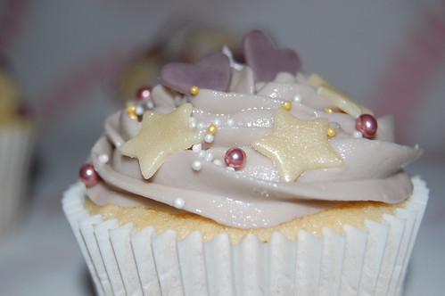Vanilla cupcake, vanilla frosting decorated with chocolate violets and hearts.
