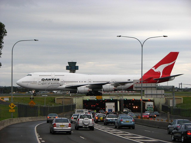 Airplane over road cars Australia Qantas