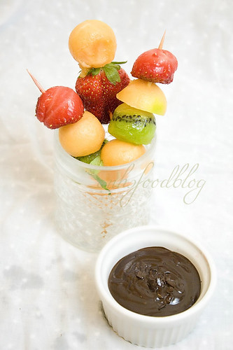 Fruit skewers with warm chocolate sauce