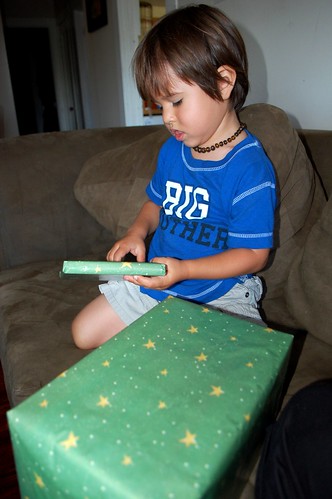 opening his presents from baby sister