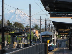 A train leaves the Columbia City station while Mount Rainier dazzles in the background. Photo by Wendi.