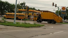 Eastbound yellow garbage truck at the intersection of Central and Greenwood Roads. Glenview Illinois. Late August 2009.