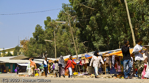 Shoppers and merchants line the side of the road in a market area of Addis Ababa, Ethiopia..