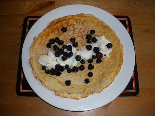 Pancake with vanilla ice cream and blackberries