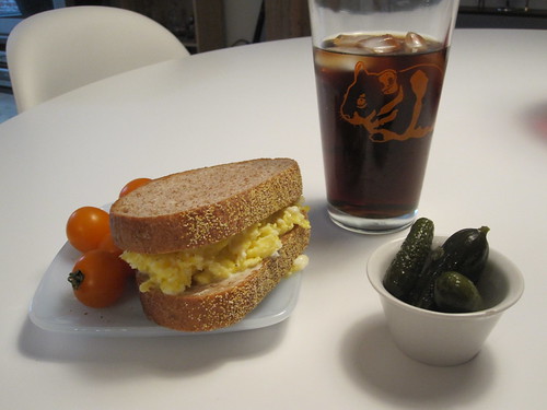 Egg sandwich, tomatoes, pickles, Diet Coke at home