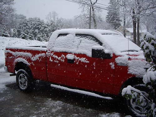 The little red truck covered in snow