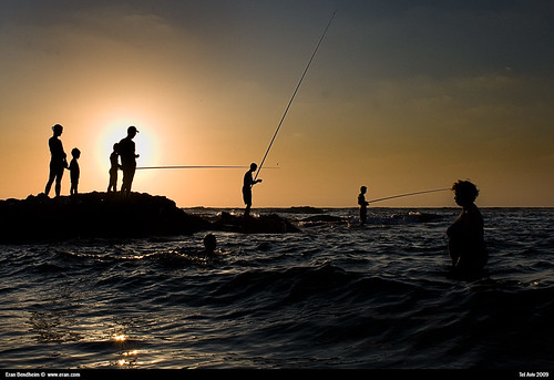 fisherman in tel aviv at sunset