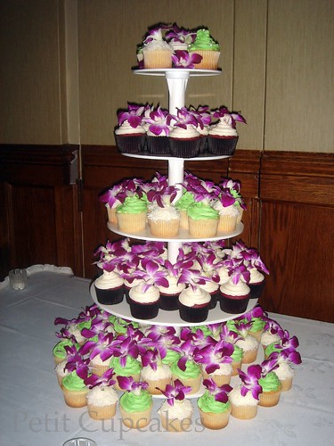 A cupcake tower filled with purple orchids for Candice Ben's Wedding