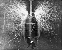 Nikolai Tesla, reading by the light of the Tesla Coil by pictura poesis