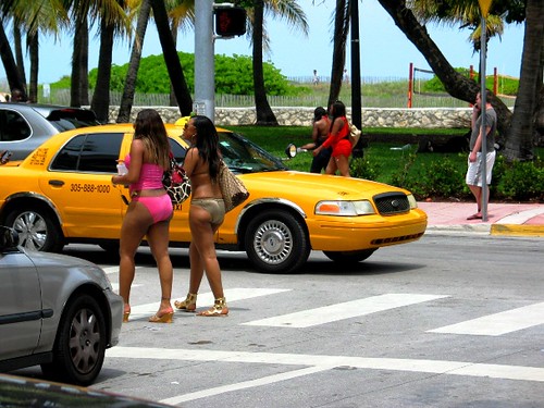 South Beach Beauties in bikini walking by cars