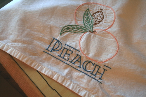 Embroidered teal towel, peach