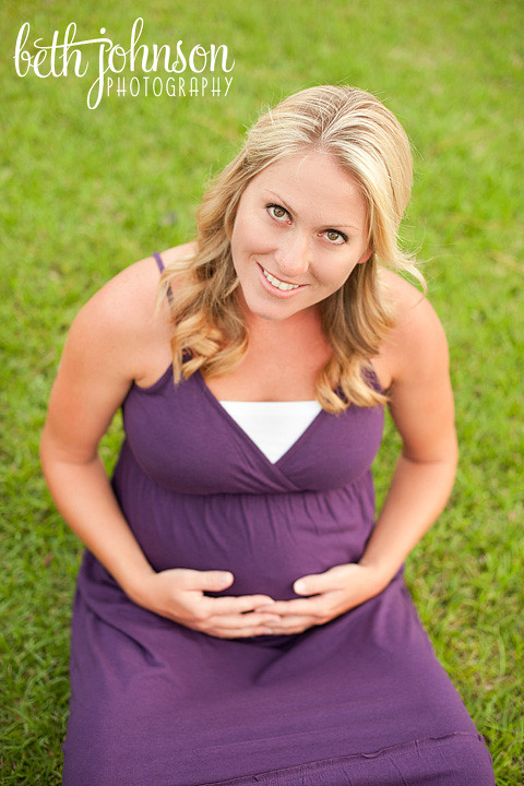 pregnant mommy in purple dress looking up maternity session