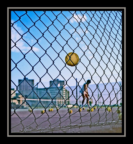 Tennis ball caught in the wire-net 