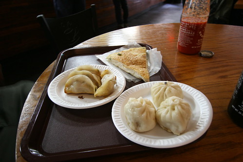 The famous dumplings flanked by pork buns and sesame pancake.