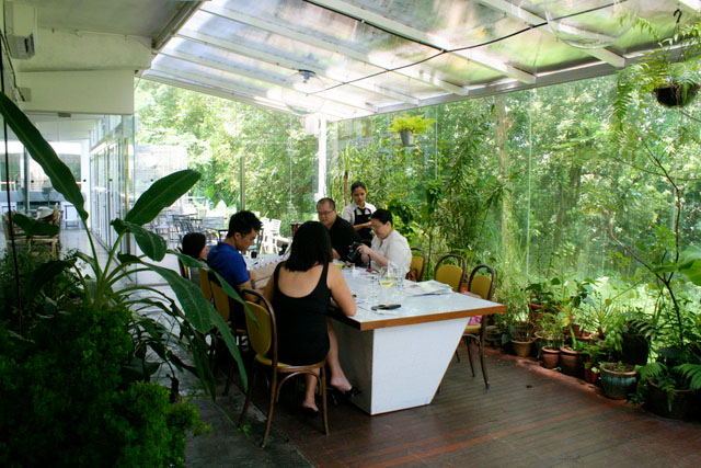 The Greenhouse, a lush, glass-encased private dining area
