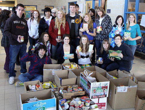 DHS Leadership pose with the results of the annual DHS food drive.