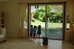 3 year olds watching Ah Gong get the pool ready for them