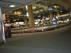 The bright lights and signs at the luggage carousel at the Las Vegas airport.
