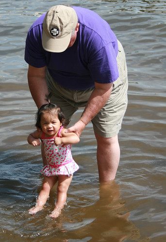 Grandpa swings Hannah around in the lake water for the first time