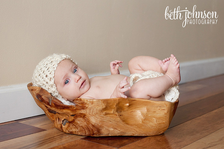three month baby girl in wooden trencher bowl
