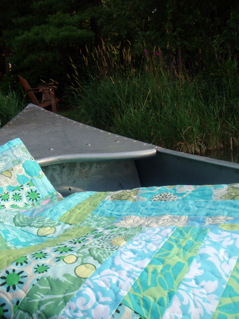 blue green strip quilt in a canoe (?!?)