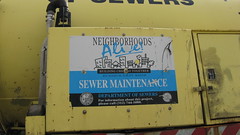 Advertising on the side of a Chicago Department of Sewers truck in traffic. Chicago Illinois. Early November 2009.