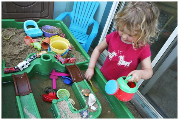 Toddler playing at her sand and water table