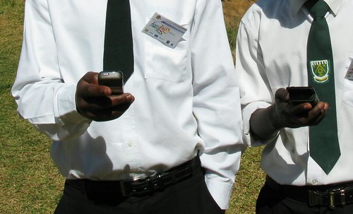 Zambian learners on their mobile phones (Source: Steve Vosloo, CC-BY-NC-SA)