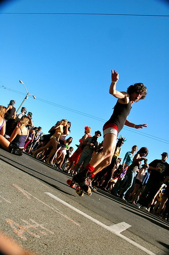 A roller skater glides past City Hall at LovEvolution enjoying the electronic music.  Photo by Adam Ross/Foghorn