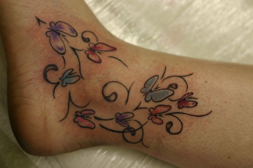  butterflys and tribal tattoo around ankle 