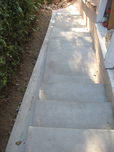 new stairs on side of house, with drainage