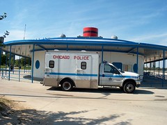 Chicago Police Department patrol wagon parked by the North Avenue Beach concession stand / Locker room building. Chicago Illinois. Early September 2006.