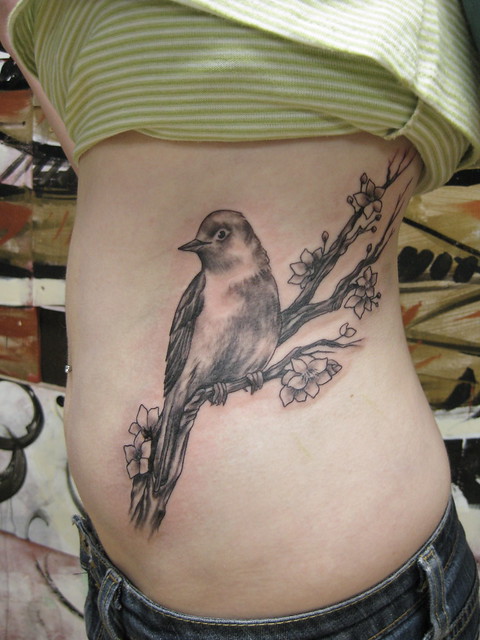 Nightingale on apple blossom branch. Drawn and tattooed by Kai Smart