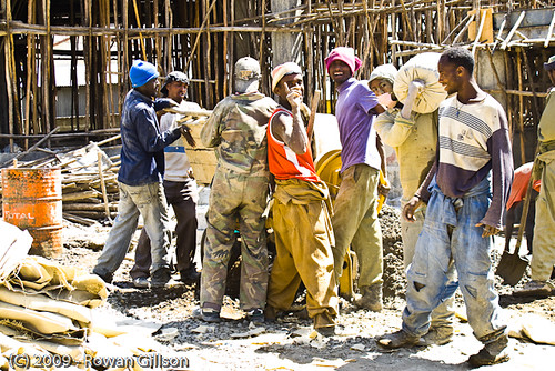 Ethiopian construction workers pause to wave and pose for the camera at a construction site in Addis Ababa..