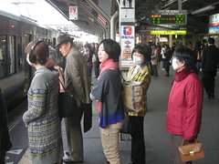Lined up, wearing masks