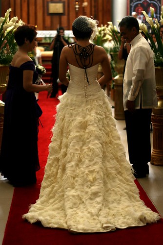 The bride's todiefor necklace and ostrichfeather gown