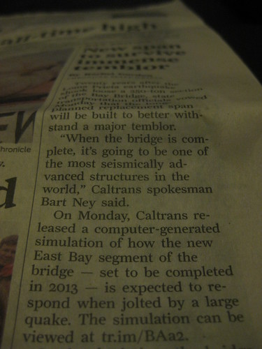 photo of a newspaper column with article text including a tr.im shortlink