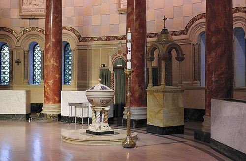 Cathedral Basilica of Saint Louis, in Saint Louis, Missouri, USA - detail of east transept, with baptismal font, holy oil ambry, confessional, and paschal candle 