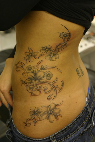 flower tattoos on spine. Flowers and florishes on side