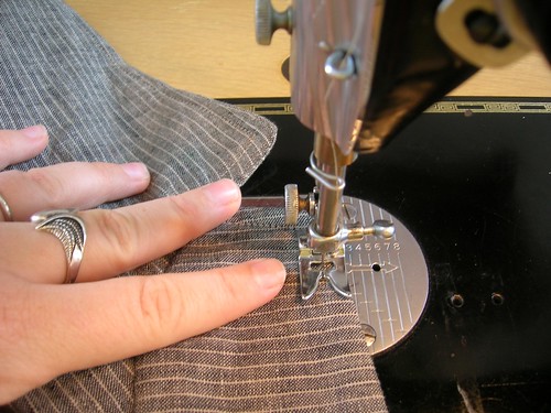 Topstitching around the perimeter of the jacket, including collar.