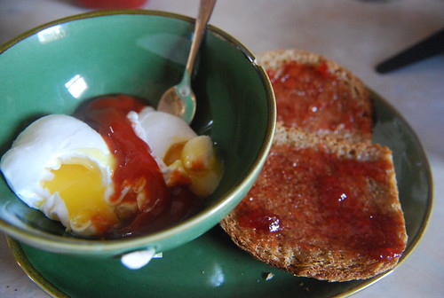 Poached eggs and toast with strawberry jam