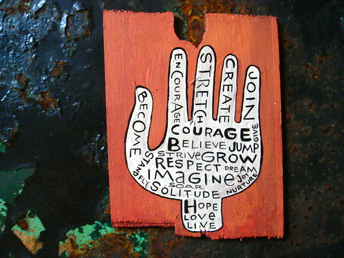 graffiti of a hand bearing such words as "courage, believe, grow, imagine, respcet..."