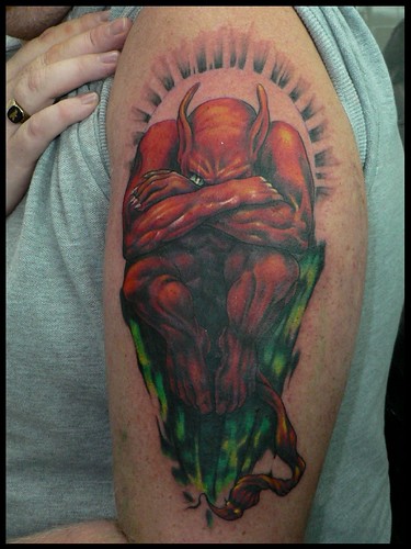 Cover up of a red devil, done by Mr. Red Dog Tattoo in Benalmádena Costa,.
