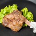 ribeye steak on black plate or pan