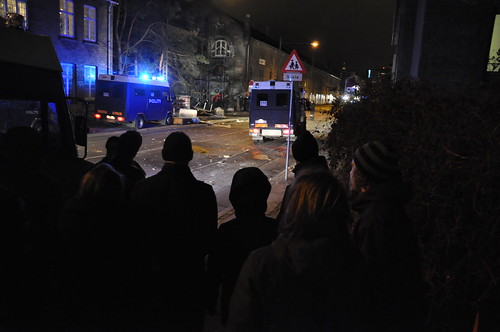People watch police outside Christiania, Copenhagen