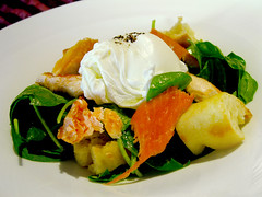Organic poached egg with smoked arctic char on a salad of mixed baby spinach greens & garlic fried croutons dressed with Dijon vinaigrette.